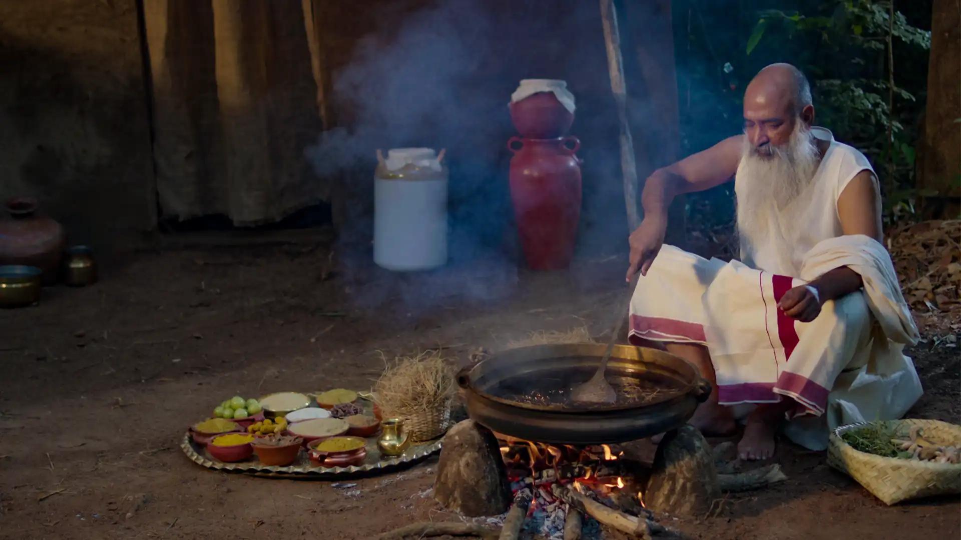 A traditional healer in Kerala prepares an Ayurvedic decoction using herbs A traditional healer in Kerala prepares an Ayurvedic decoction using herbs