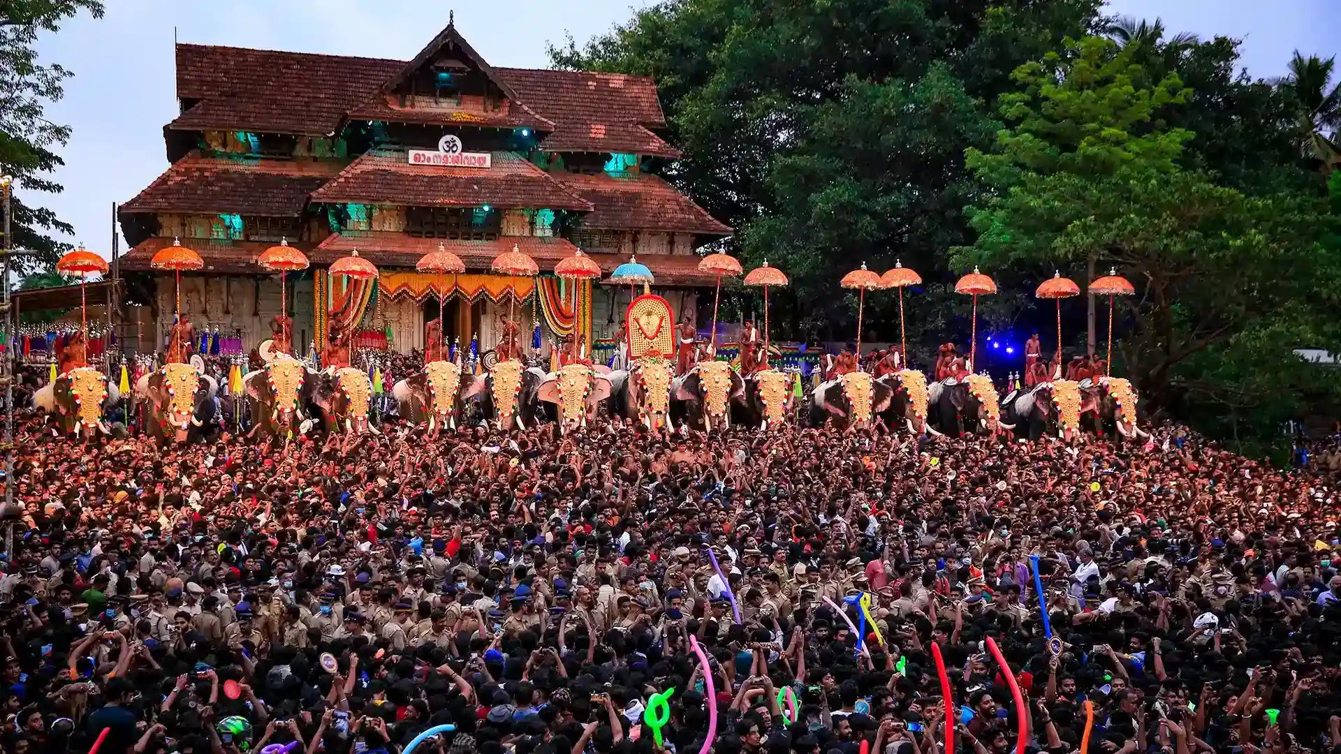 Majestic caparisoned elephants stand tall amidst a sea of ecstatic devotees at Thrissur Pooram Majestic caparisoned elephants stand tall amidst a sea of ecstatic devotees at Thrissur Pooram